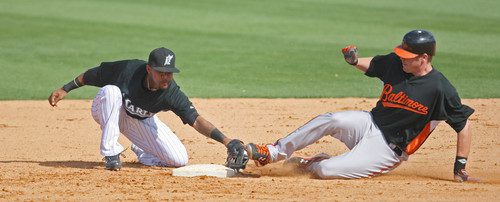 Matt Wieters slides into second under future Oriole Robert Andino's tag